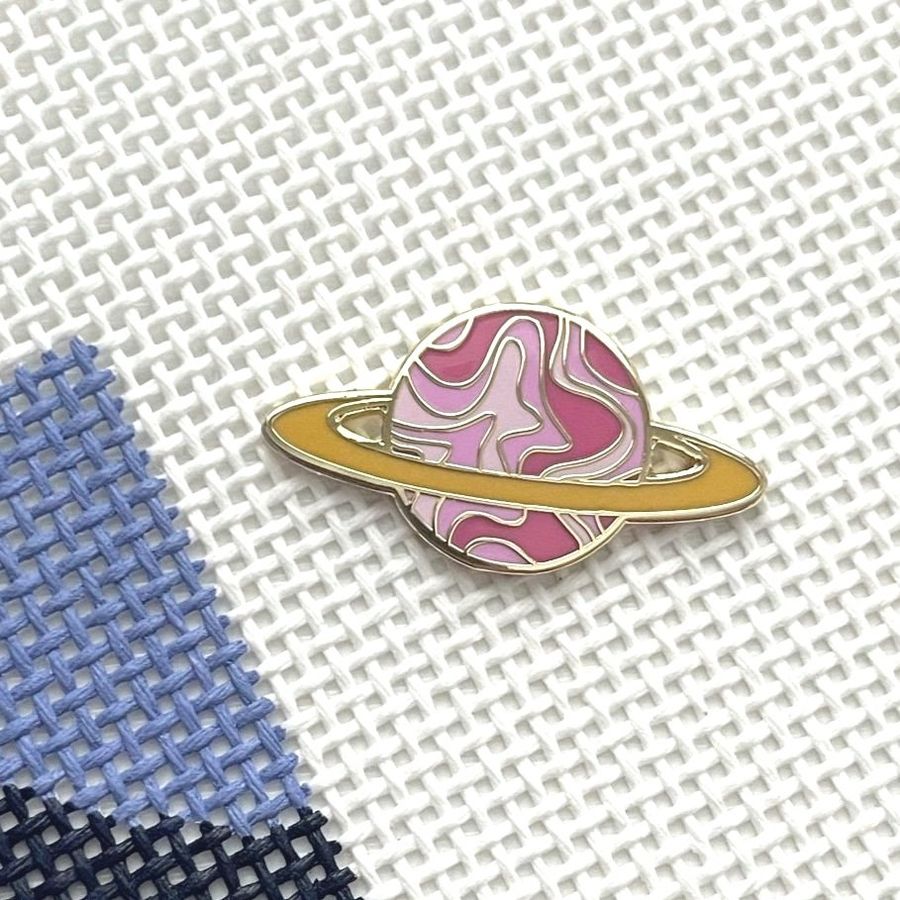 Saturnalia Logo Needle Minder Saturnalia